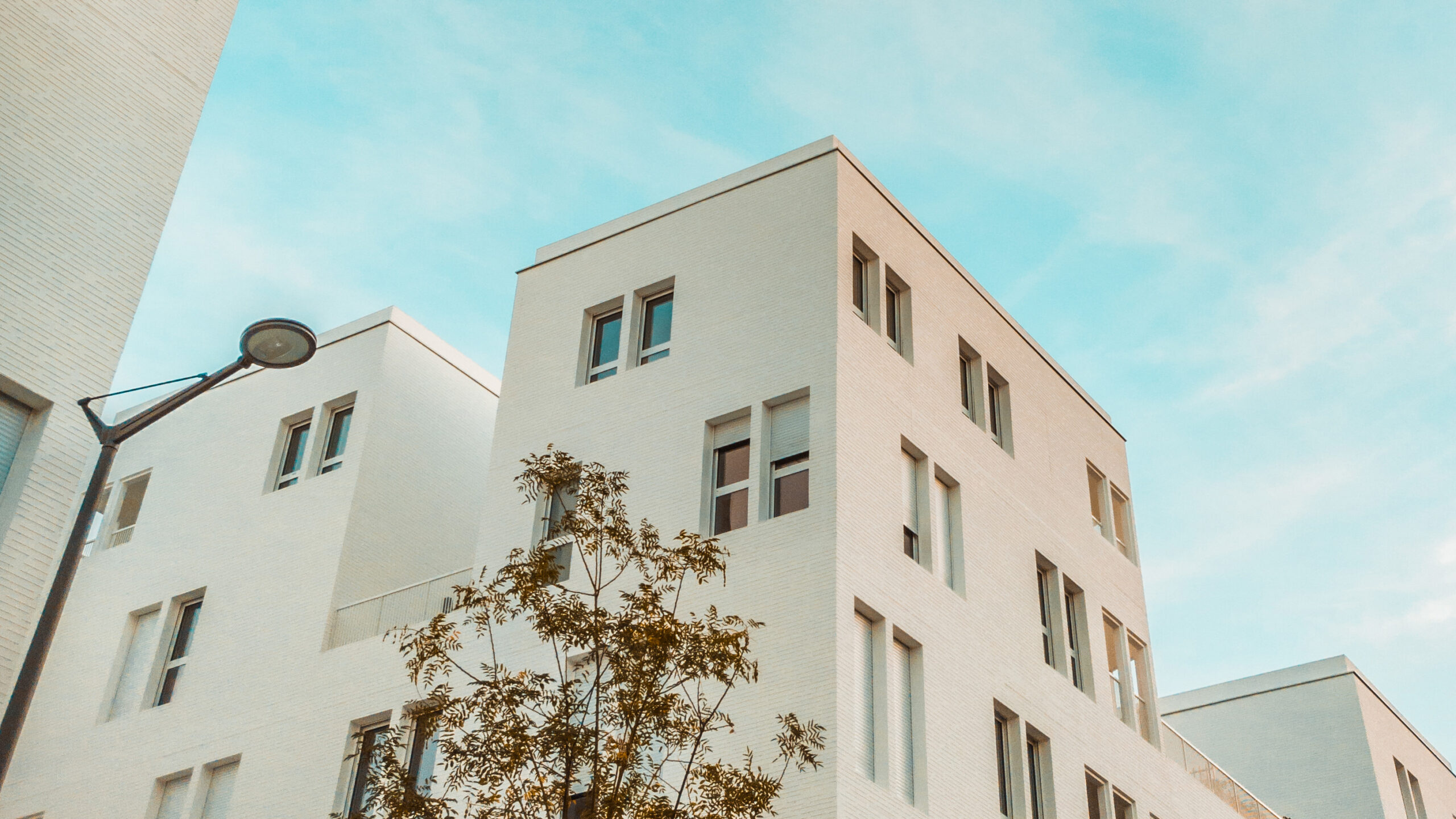 white-building-cloudy-sky_edit16x9